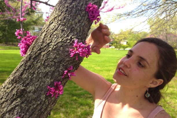 a person holding a purple flower