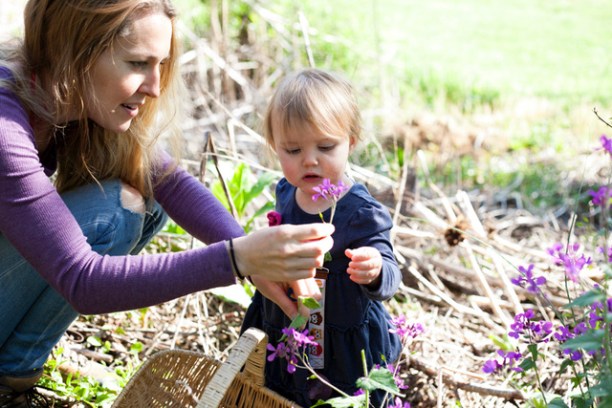 a little girl that is standing in the grass